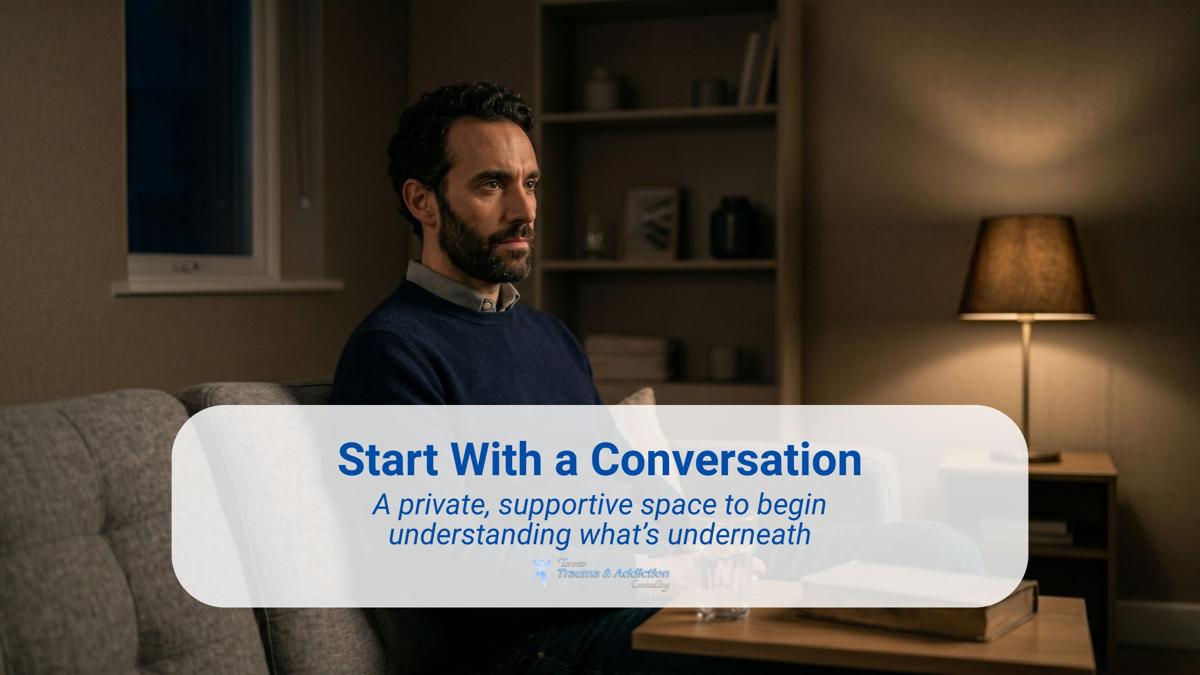 Man sitting alone in a dimly lit therapy room with warm lighting, representing beginning trauma counselling in a private and supportive environment