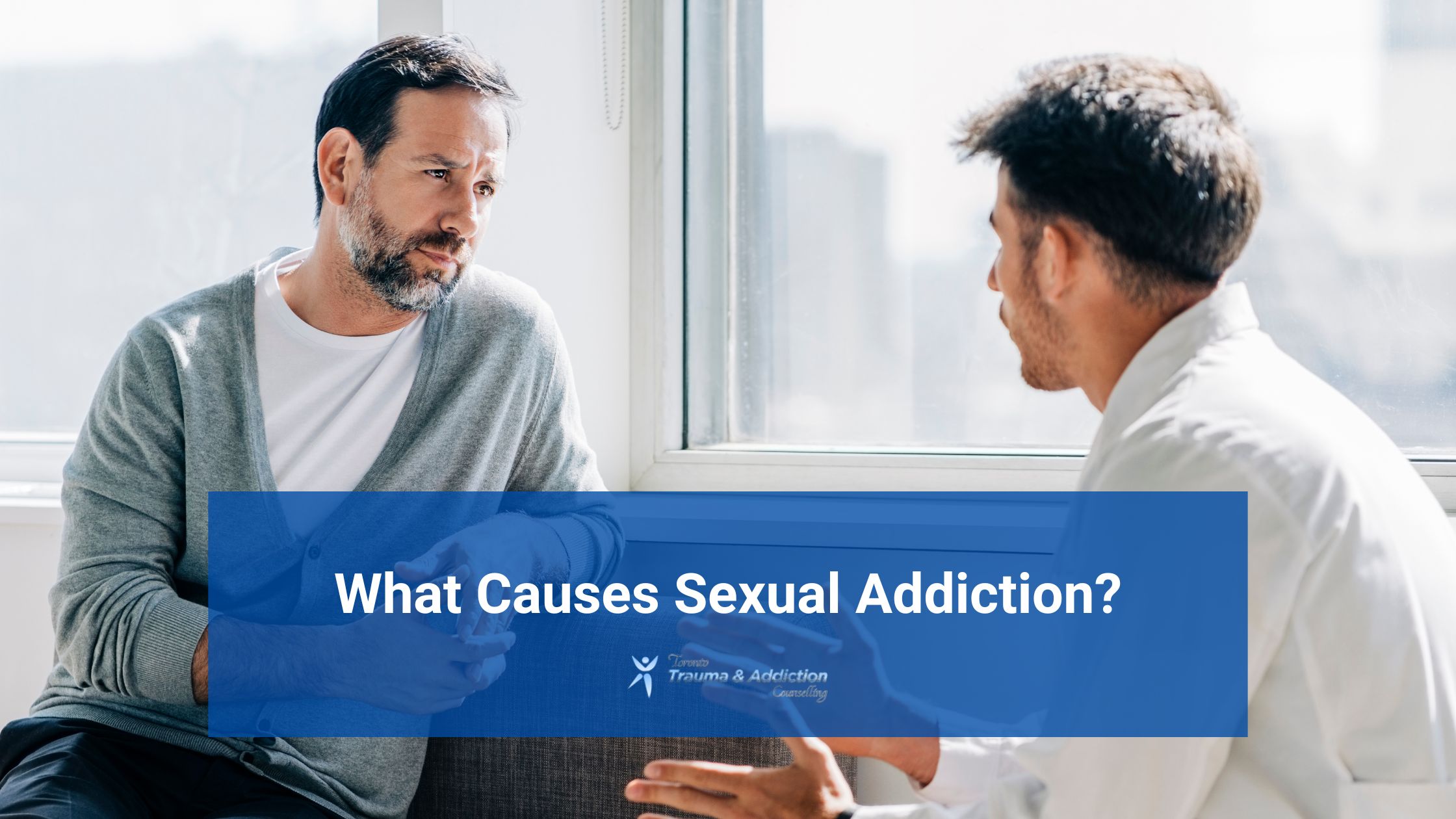 A therapist speaking with an adult man in a private counselling session, representing a supportive conversation about the underlying causes of sexual addiction.